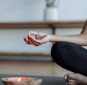 Close-up of hands in a specific yoga mudra gesture.